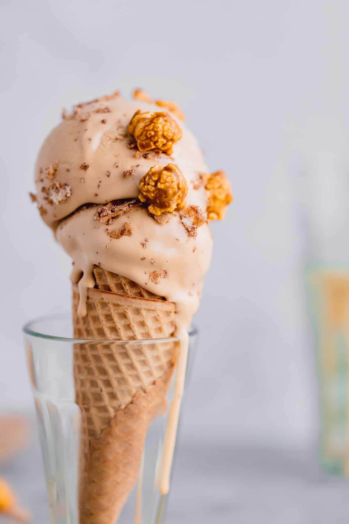 Dulce de leche ice cream in a cone topped with caramel popcorn. 