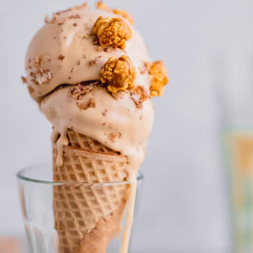 dulce de leche ice cream in a cone with caramel popcorn on top