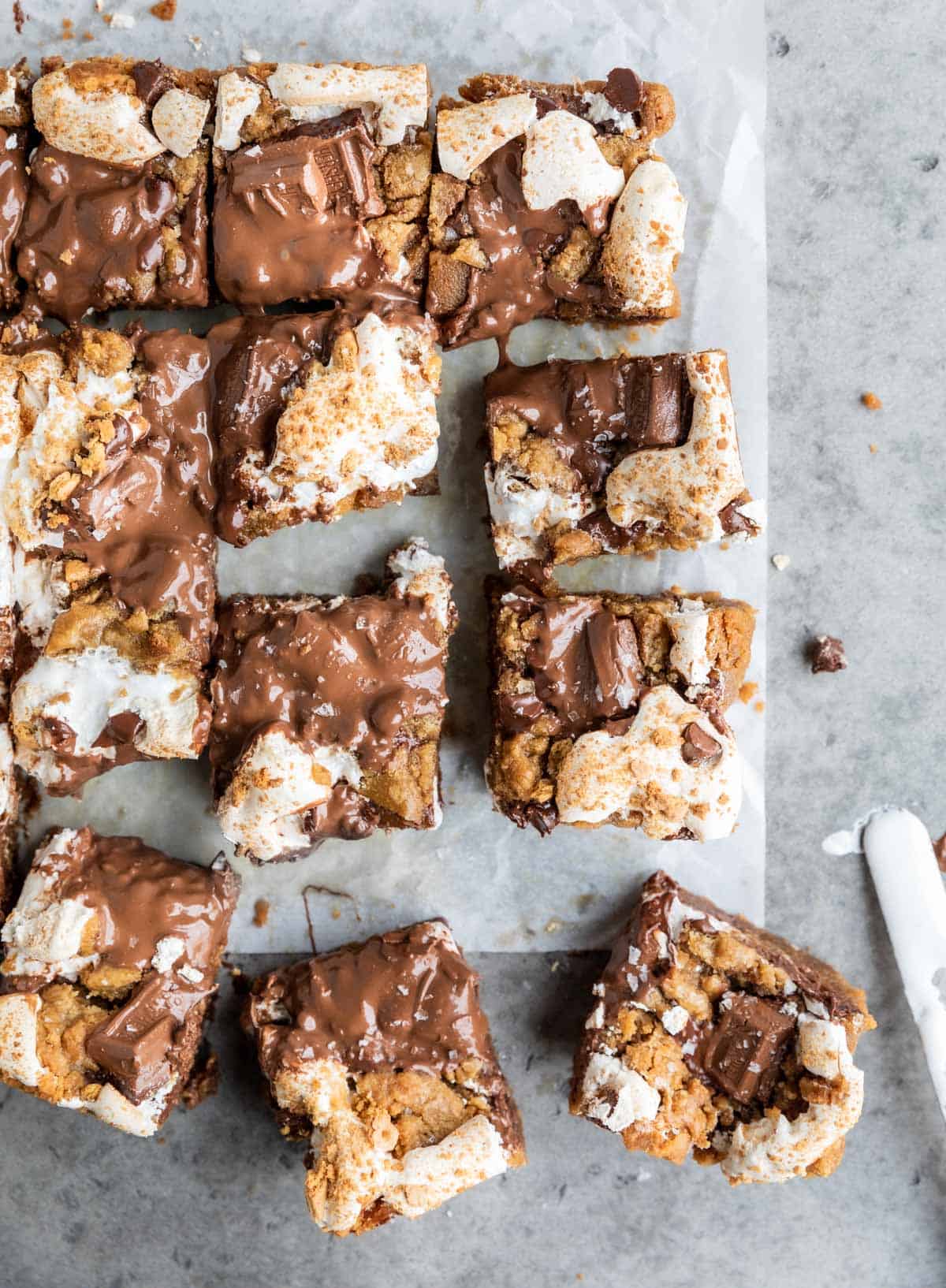 S'mores Cookie Bars cut into squares with melty Hershey's chocolate bars on top. 