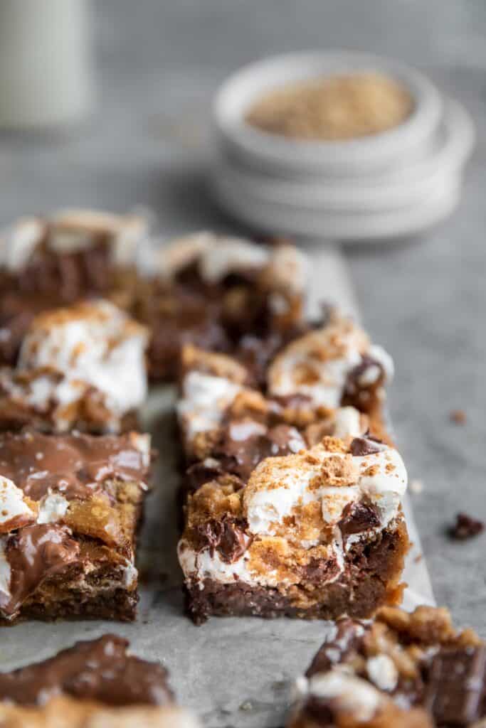 easy s'mores cookie bars cut into pieces, showing the layers of one piece