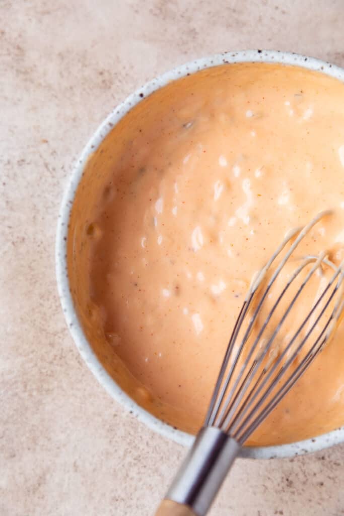 Big mac sauce in a bowl with a whisk.