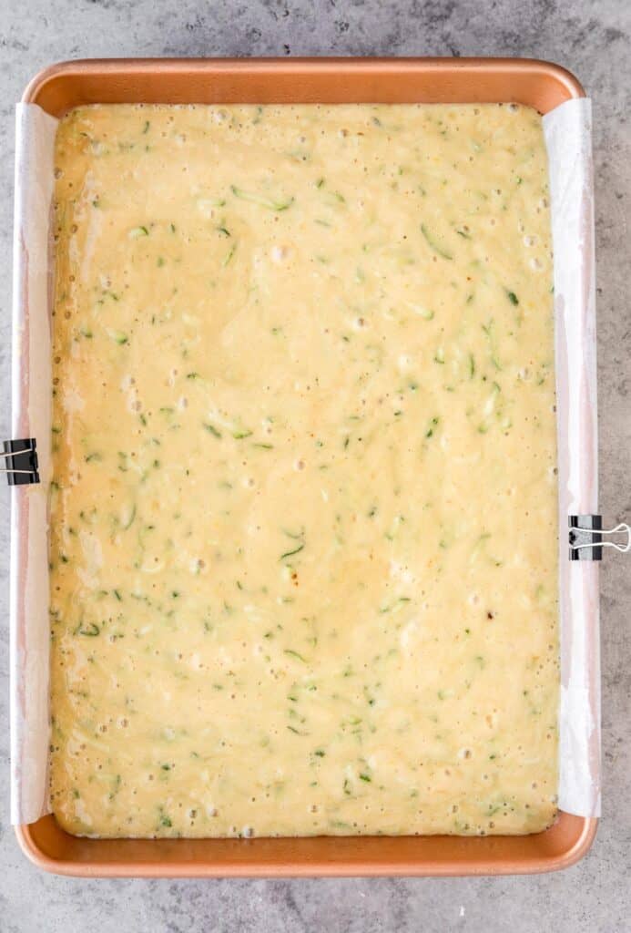 lemon zucchini cake batter poured into prepared pan 