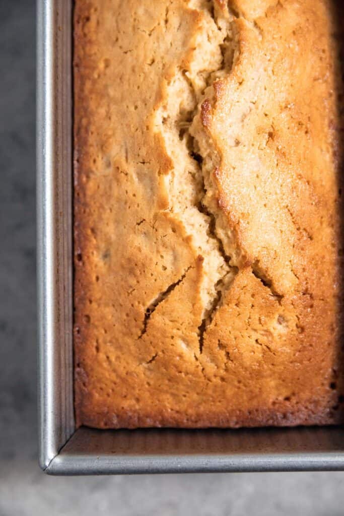Pound cake baked in a loaf pan with a crack on the top.