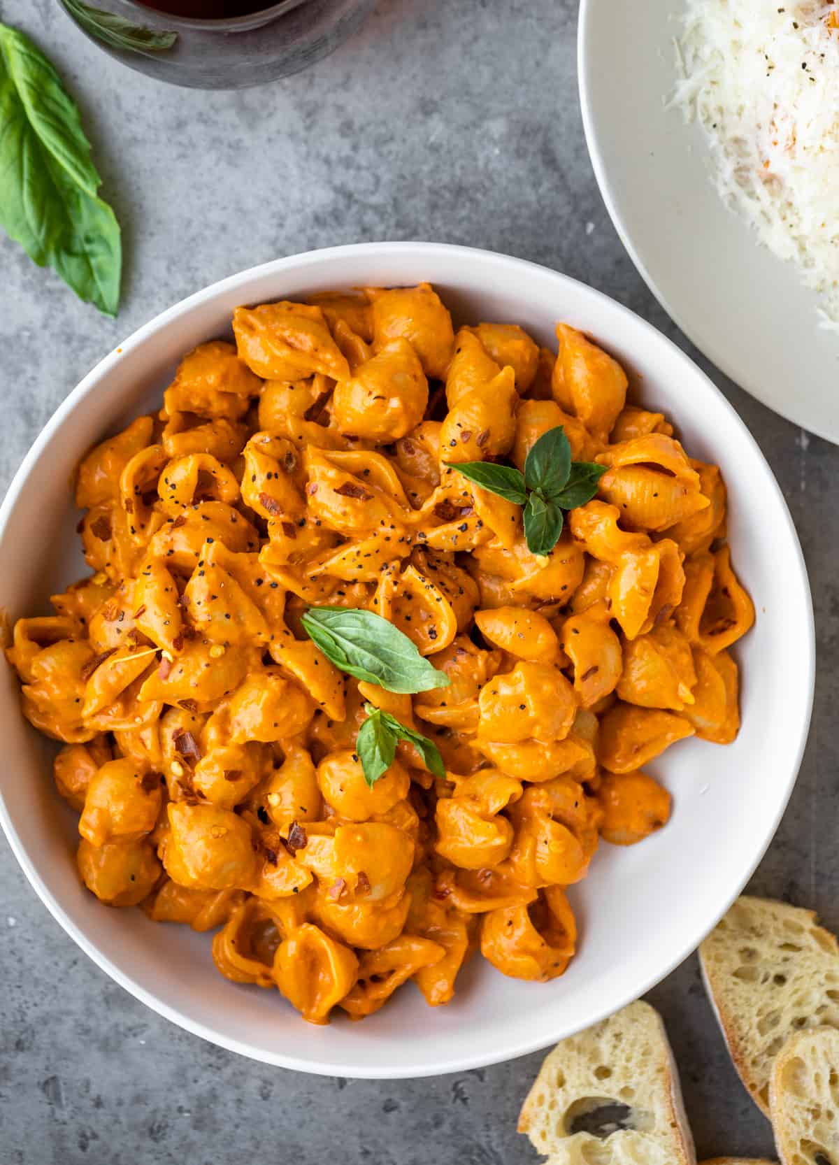 Gigi Hadid's Spicy Vodka Pasta in a white bowl topped with basil leaves.
