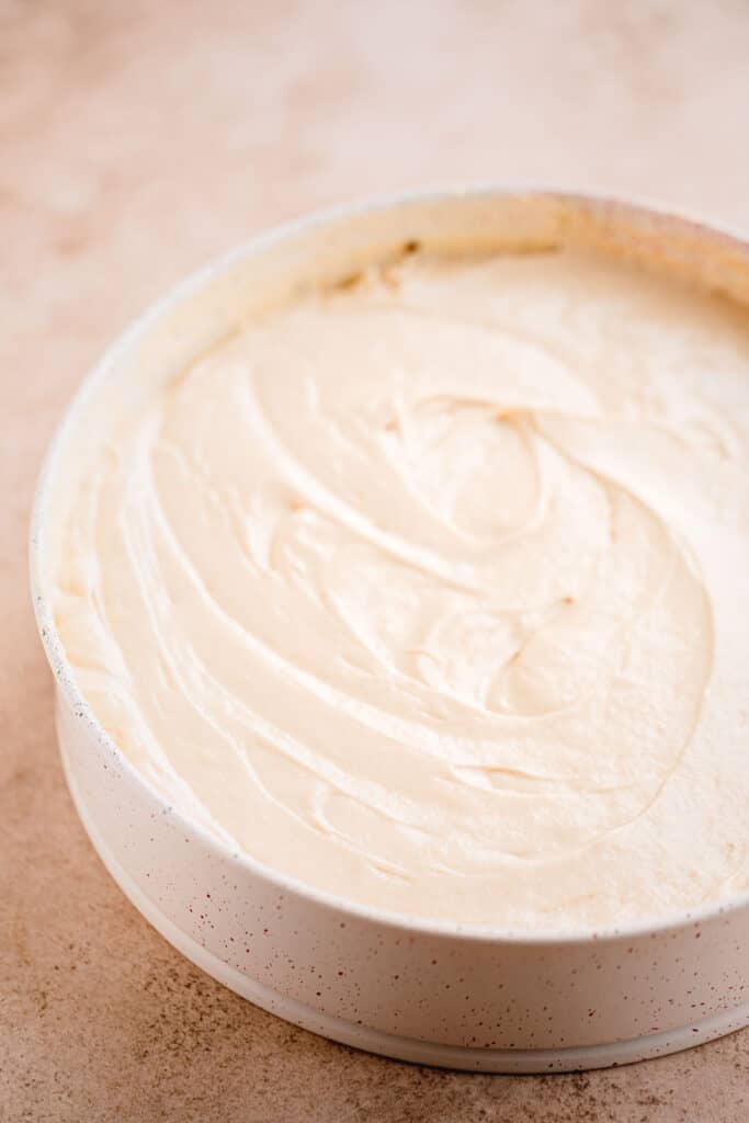 Cake batter spread over the top of the pecan mixture.