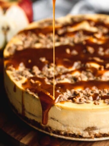 Caramel being drizzled onto a Apple Pie Stuffed Cheesecake.