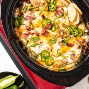 Jalapeno Popper Dip in a crockpot with chips.