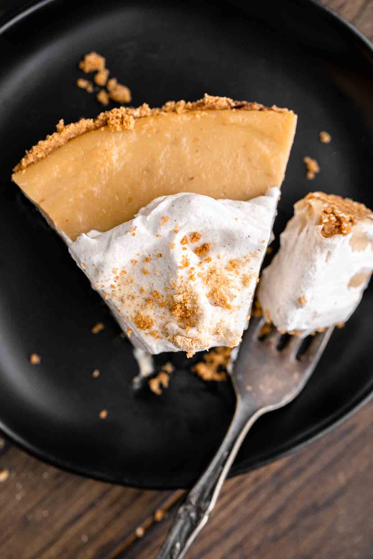 A slice of Butterscotch Cinnamon Pie with whipped cream.