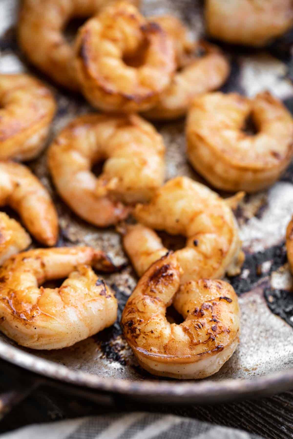 Marinated shrimp being cooked in a pan.