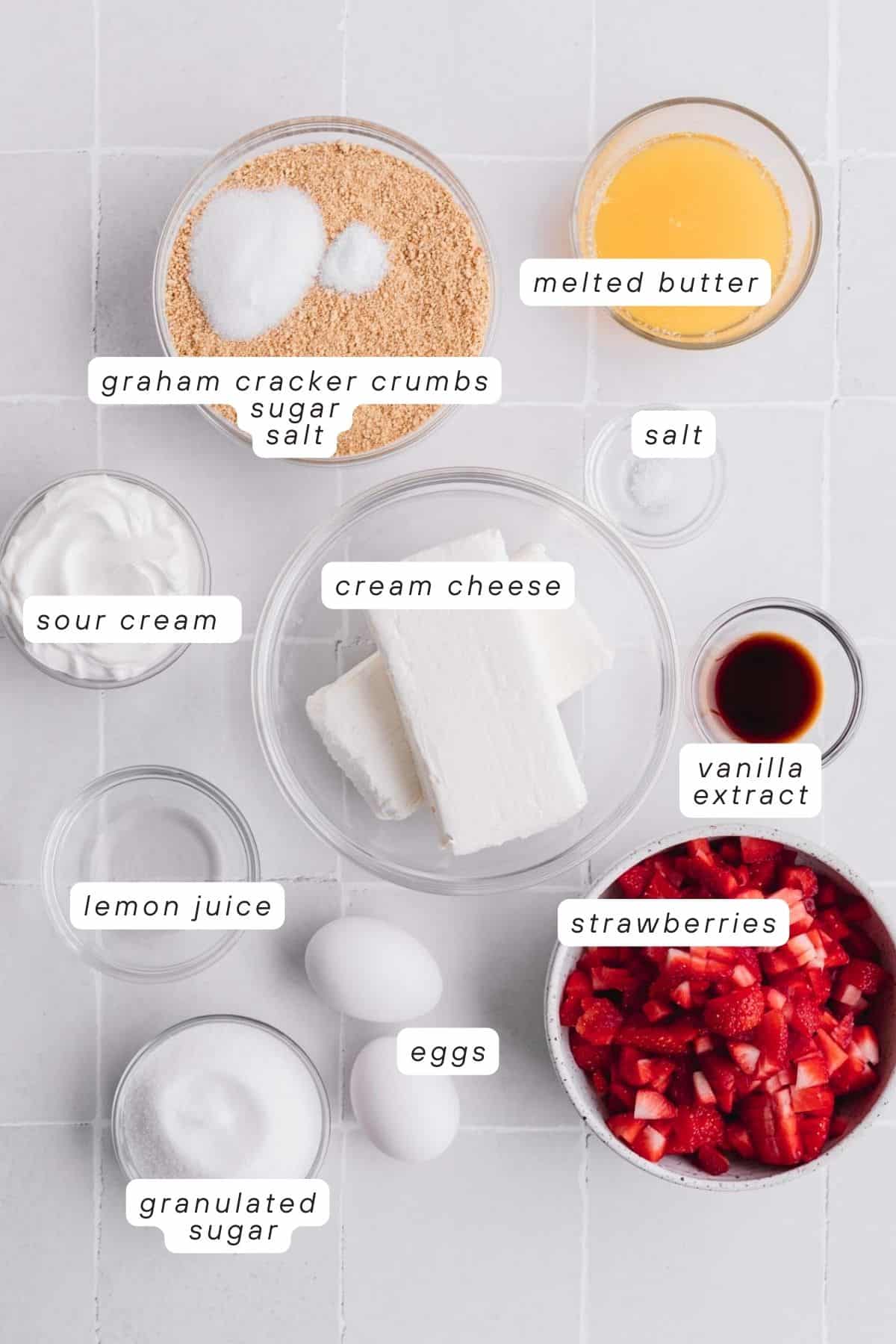 Graham cracker crumbs, sugar, salt, melted butter, cream cheese, vanilla extract, strawberries, eggs, lemon juice and sour cream. 