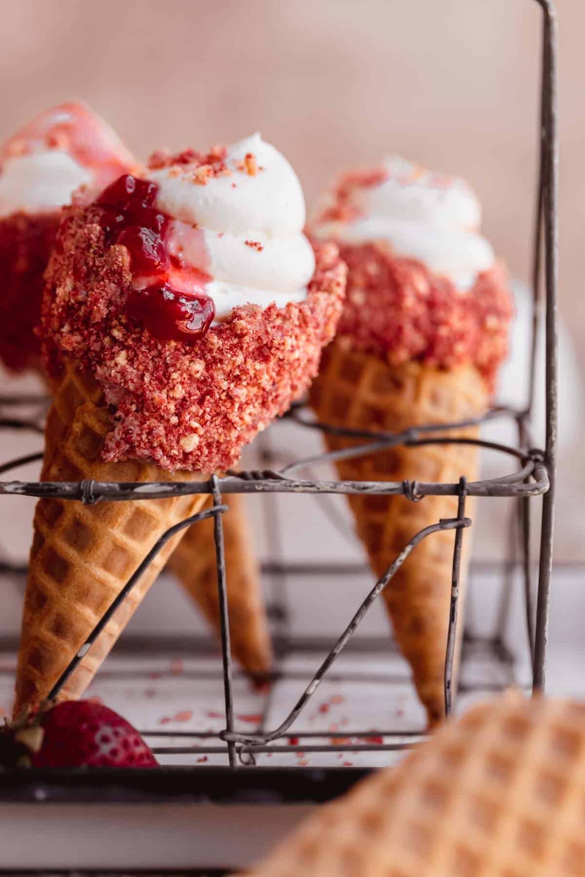 Strawberry Crunch Cheesecake Cones topped with strawberry compote.