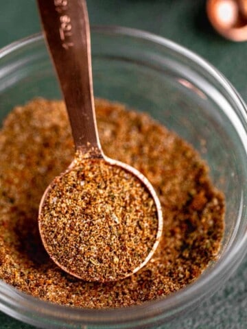 Homemade chicken taco seasoning in a small dish with a tablespoon.
