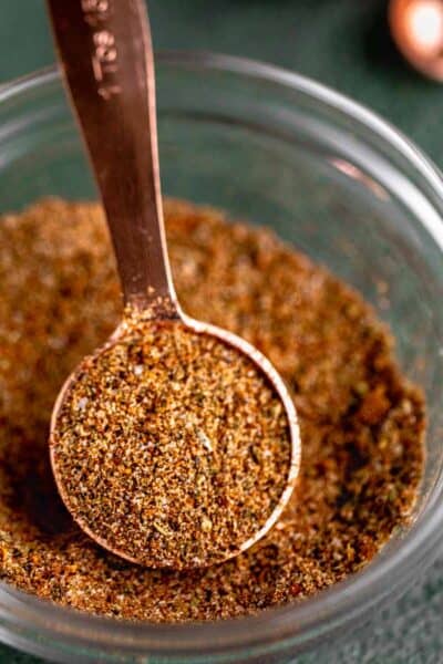 Homemade chicken taco seasoning in a small dish with a tablespoon.