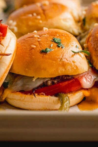 Philly cheesesteak sliders on a tray.