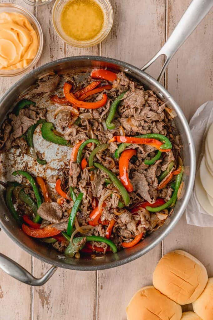 Ribeye steak sauteed with bell peppers and onions in a a large skillet.
