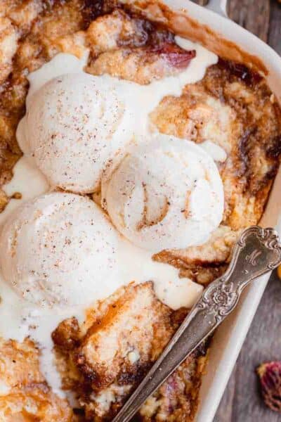 Peach cobbler with cake mix topped with vanilla ice cream.