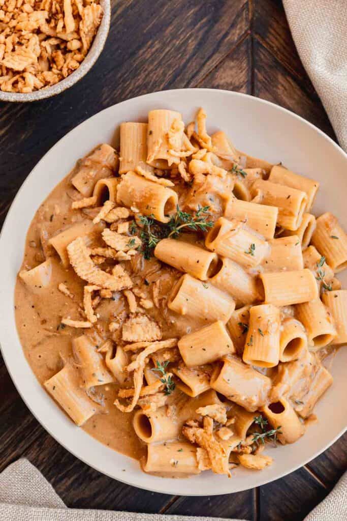 French onion pasta in a bowl garnished with fresh thyme.