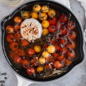 Tomato Confit with garlic in a cast iron skillet.