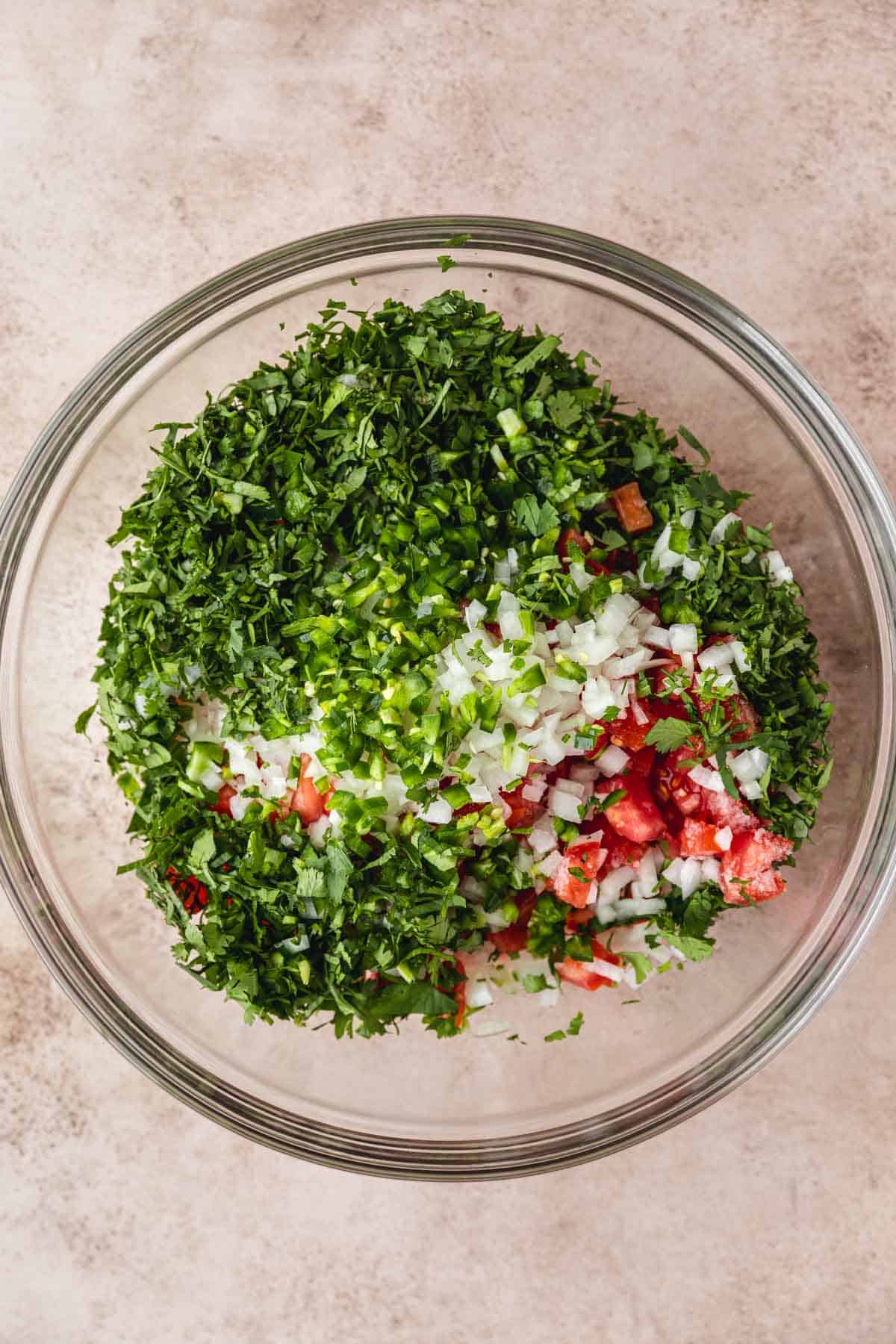 Pico de Gallo ingredients in a bowl about to be mixed up. 