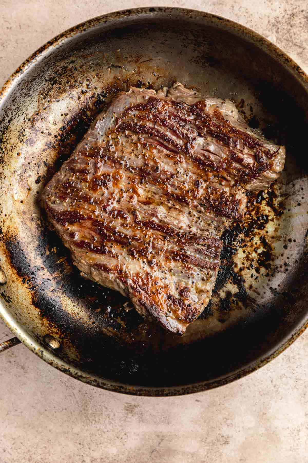 Pan seared steak in a pan. 