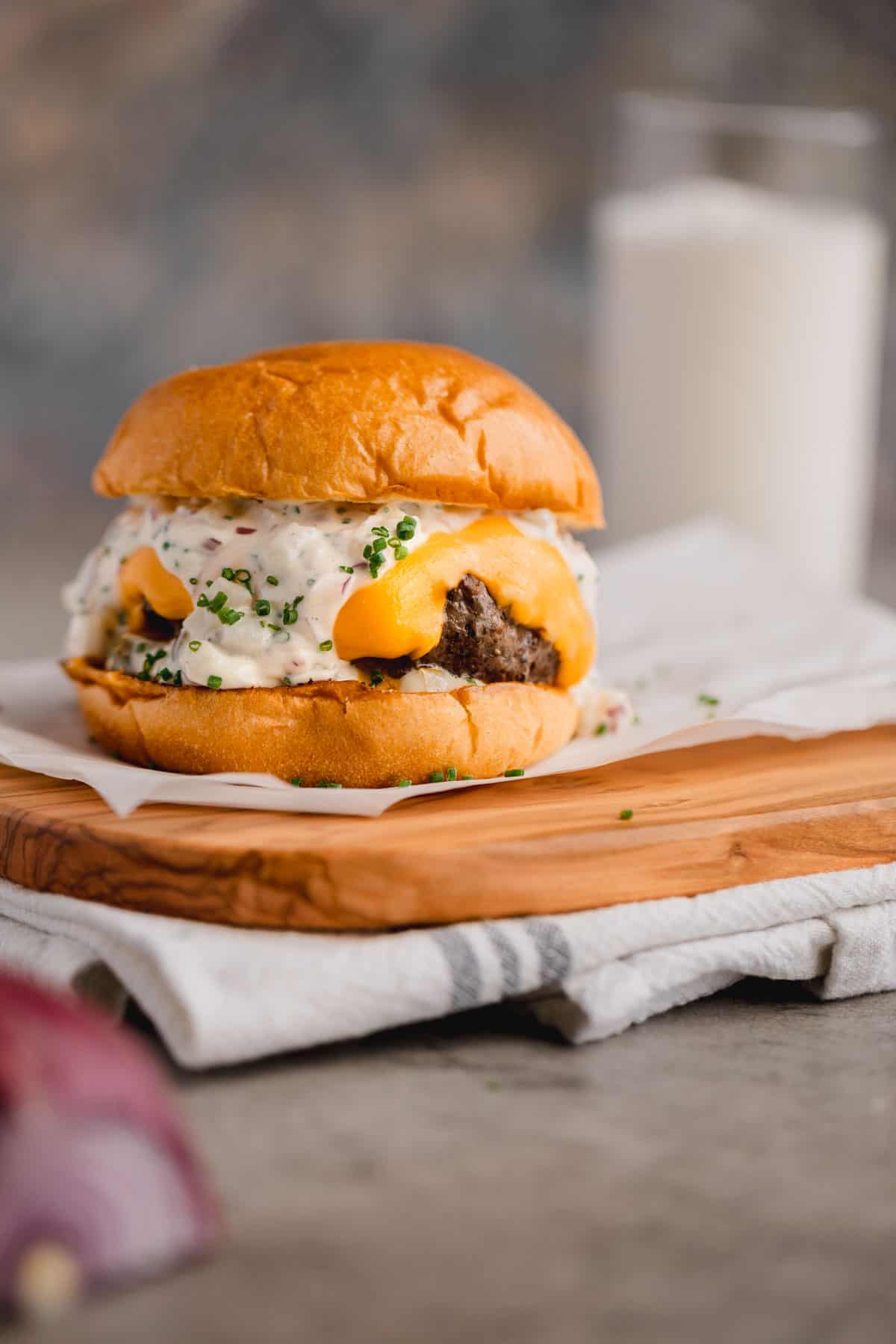 Truffle burger on a brioche bun topped with Velveeta cheese and truffle aioli. 