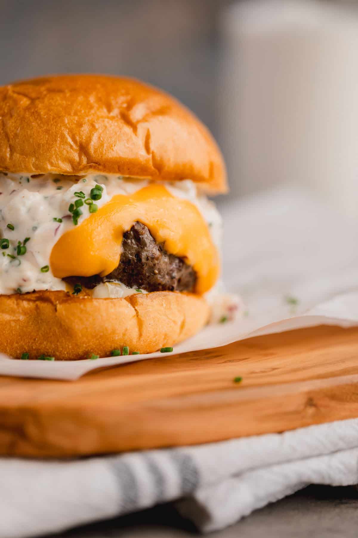 Wagyu Truffle Burger recipe with Velveeta cheese and dijonaisse on a cutting board. 