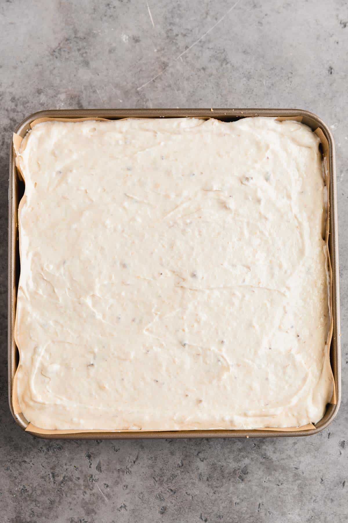 Banana pudding cheesecake square mixture put into the pan to chill overnight. 