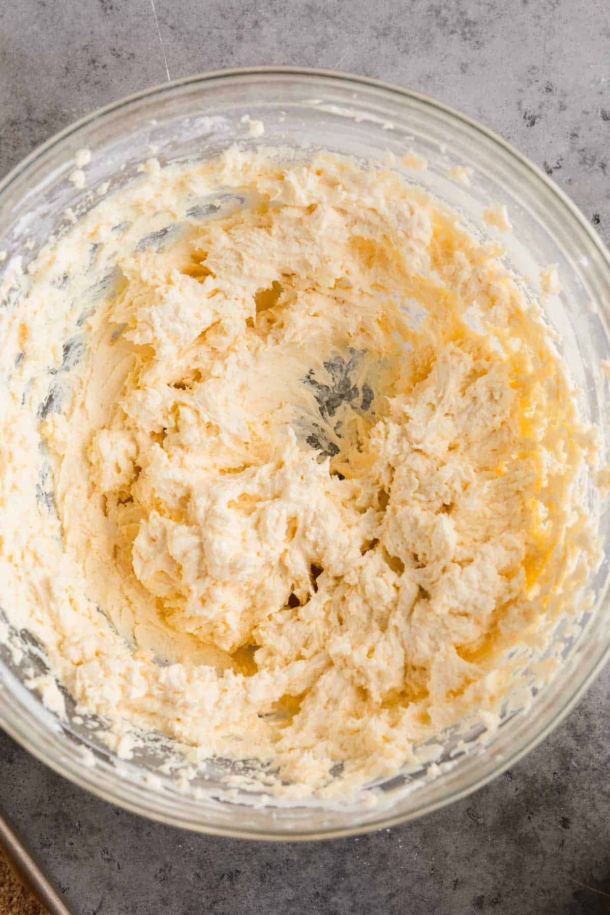 Banana pudding added to cream cheese mixture in a bowl.