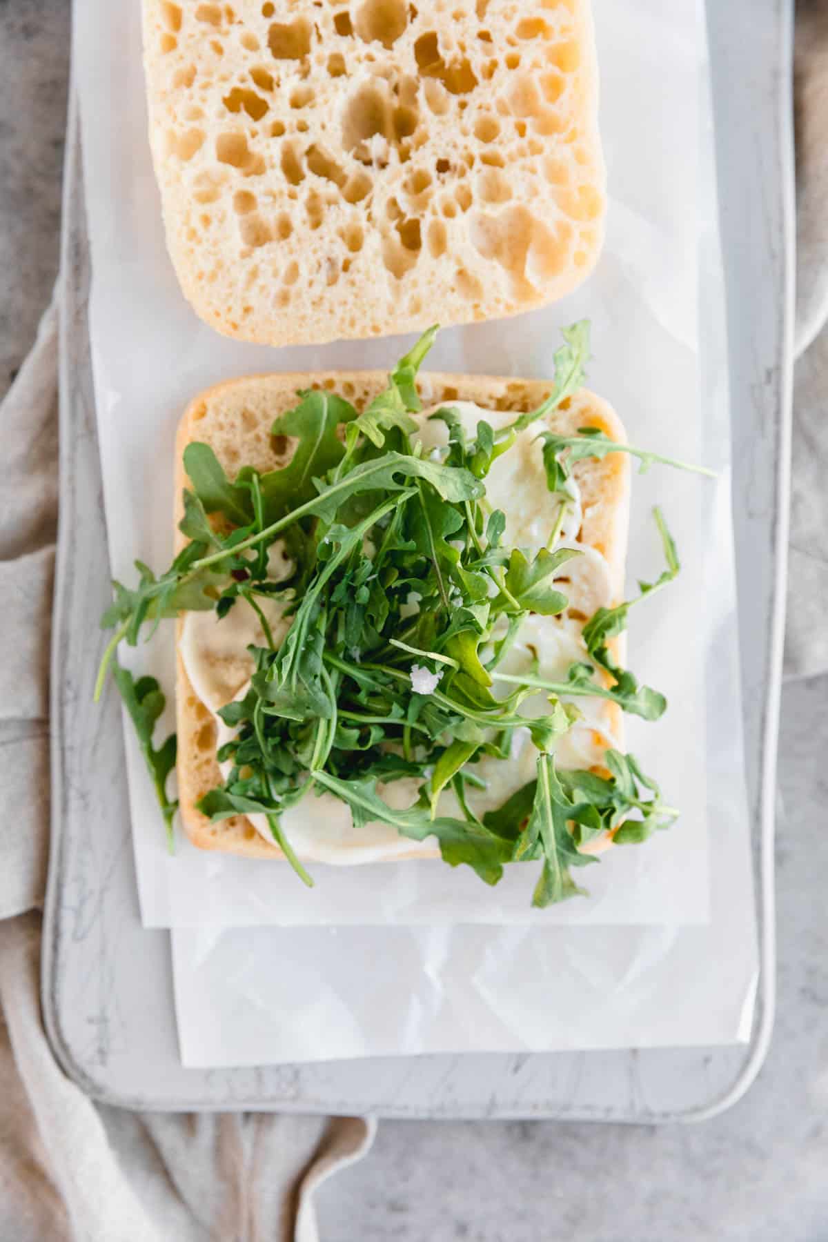 Mayo and arugula on ciabatta bread.