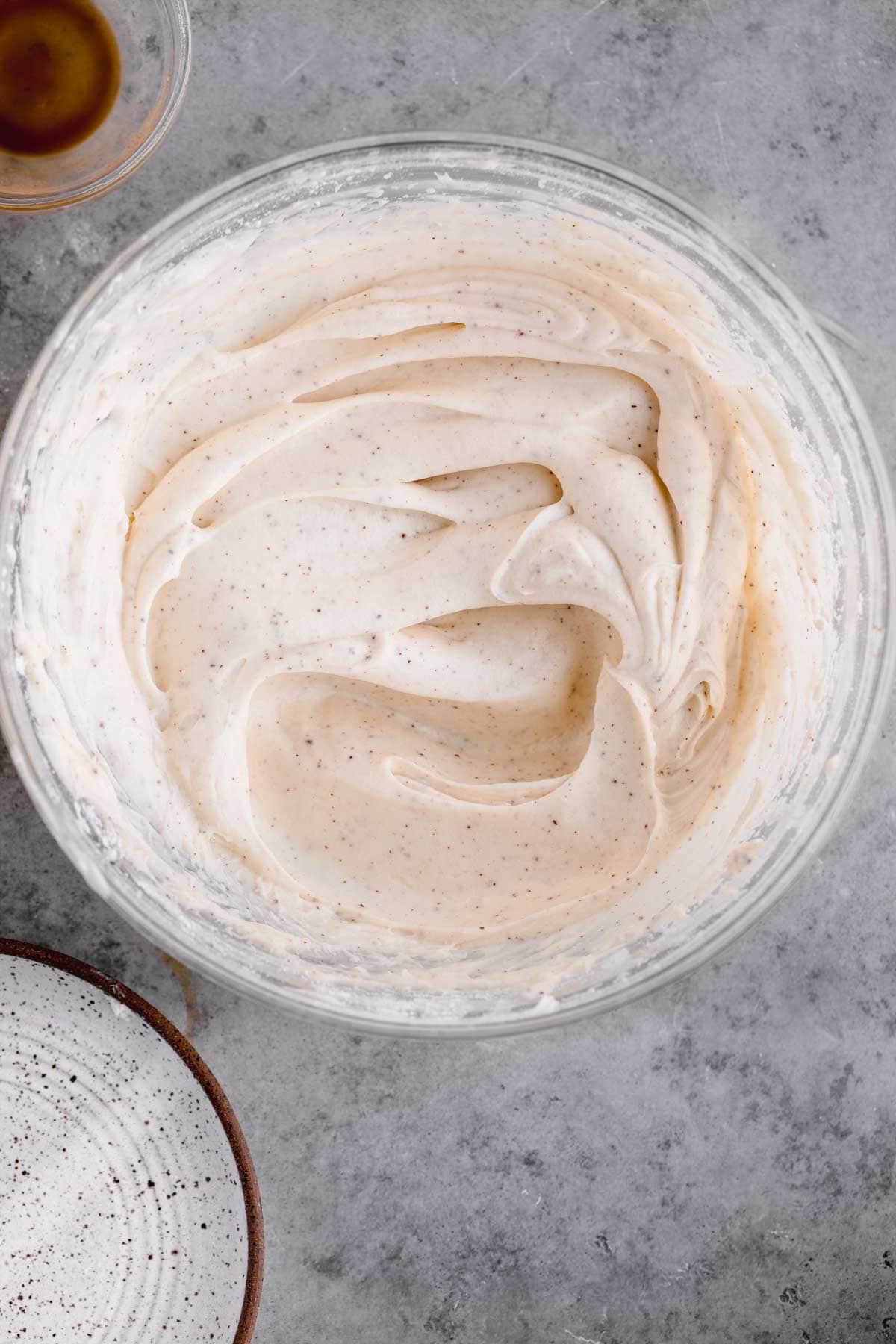 Brown butter cream cheese frosting in a large mixing bowl. 