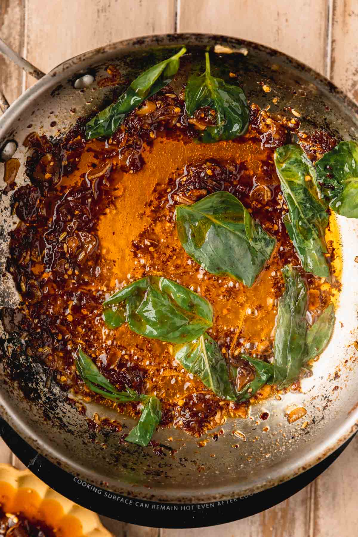 Chili oil and basil cooking in a pan. 