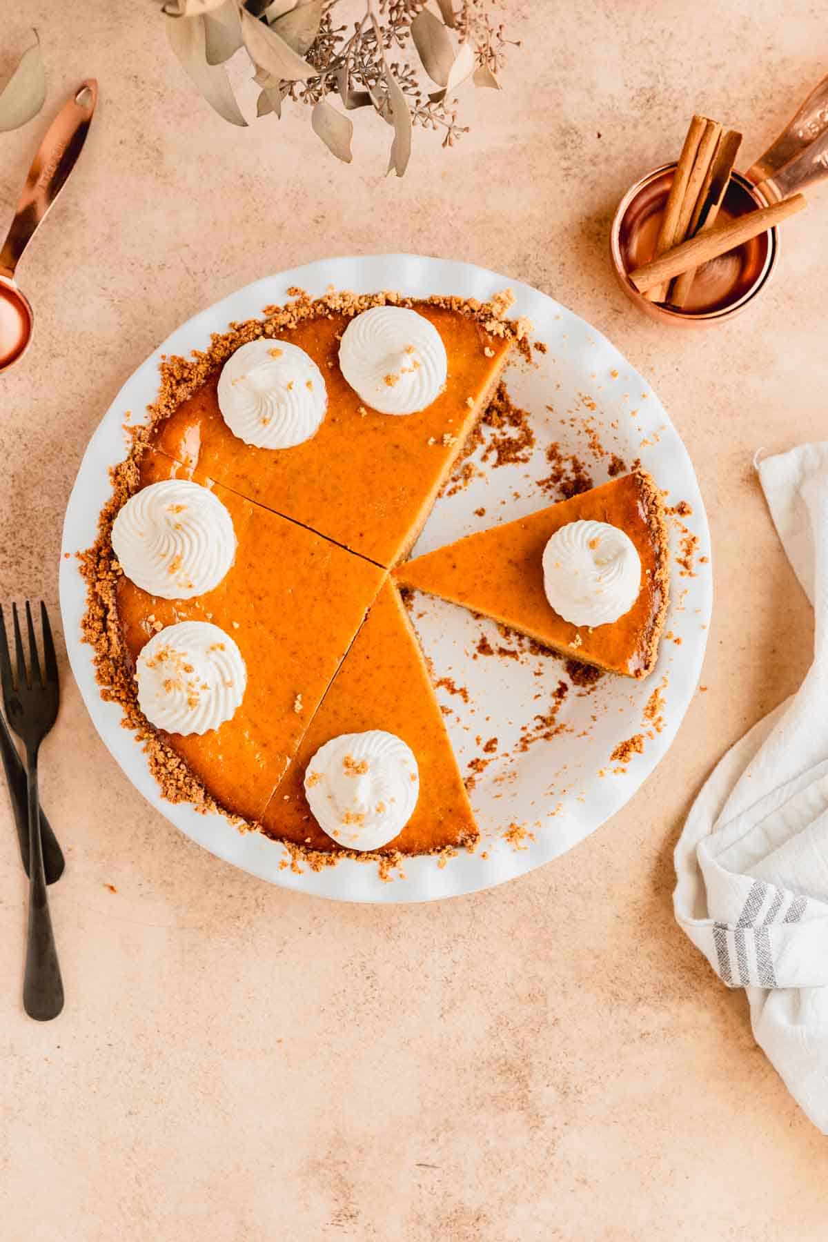 Pumpkin Pie with Graham Cracker Crust with a couple slices cut out. 