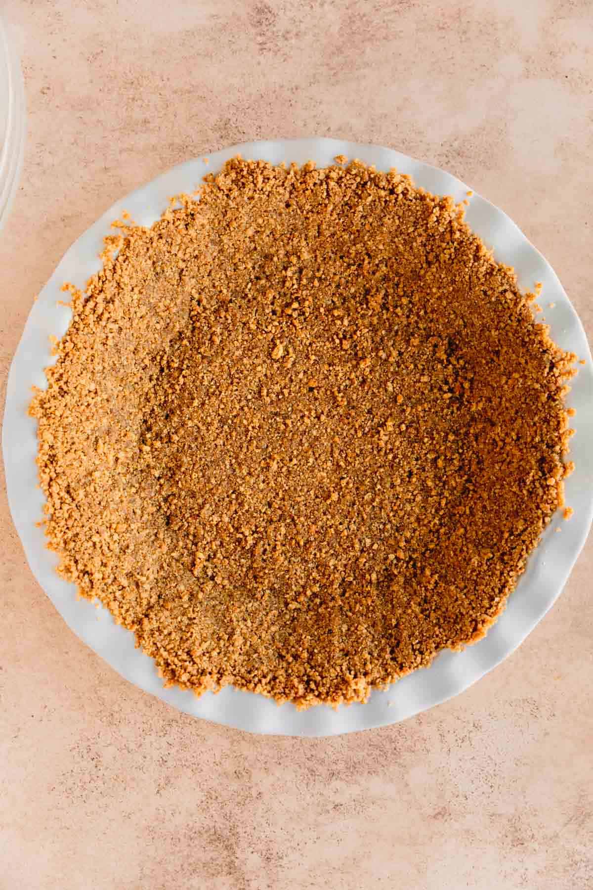 Graham cracker crust in a pie dish. 