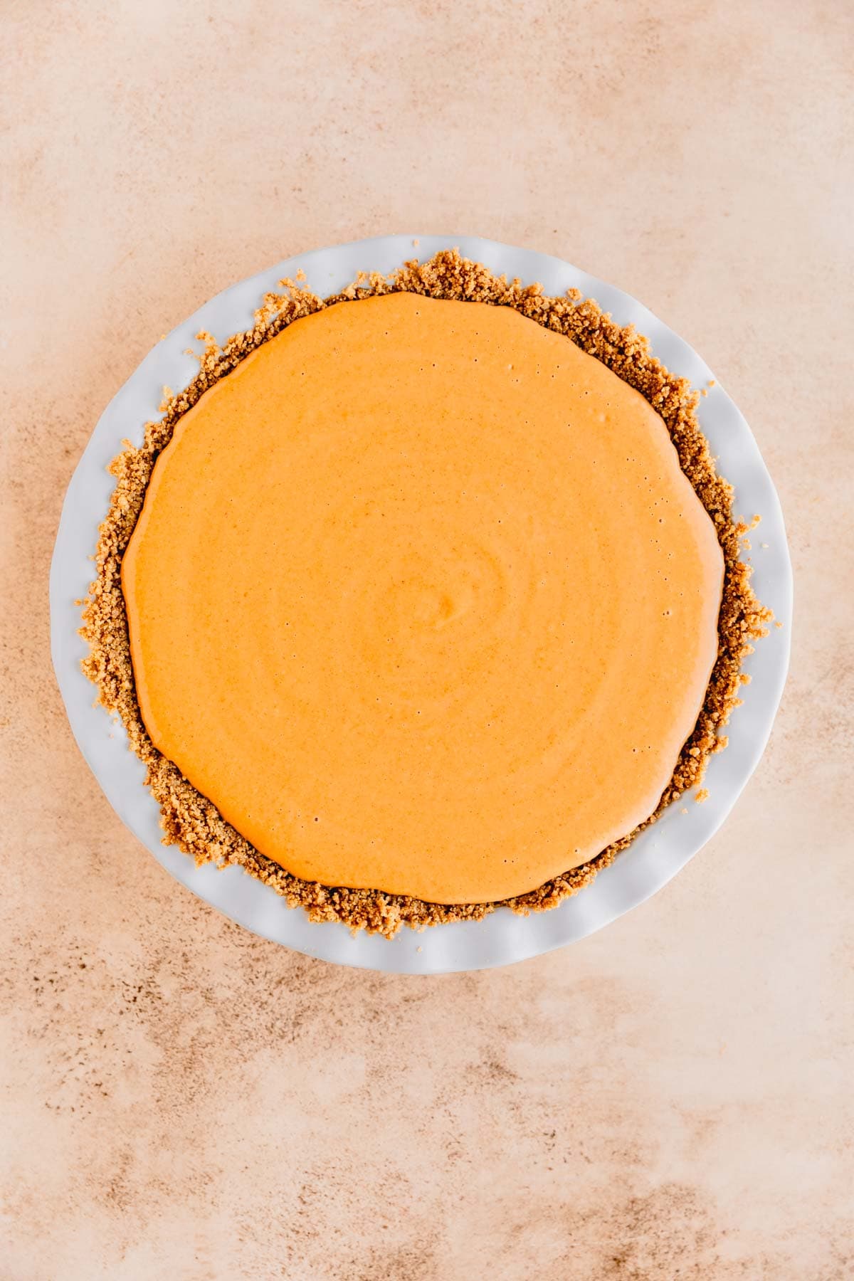 Pumpkin pie mixture poured into graham cracker crust. 