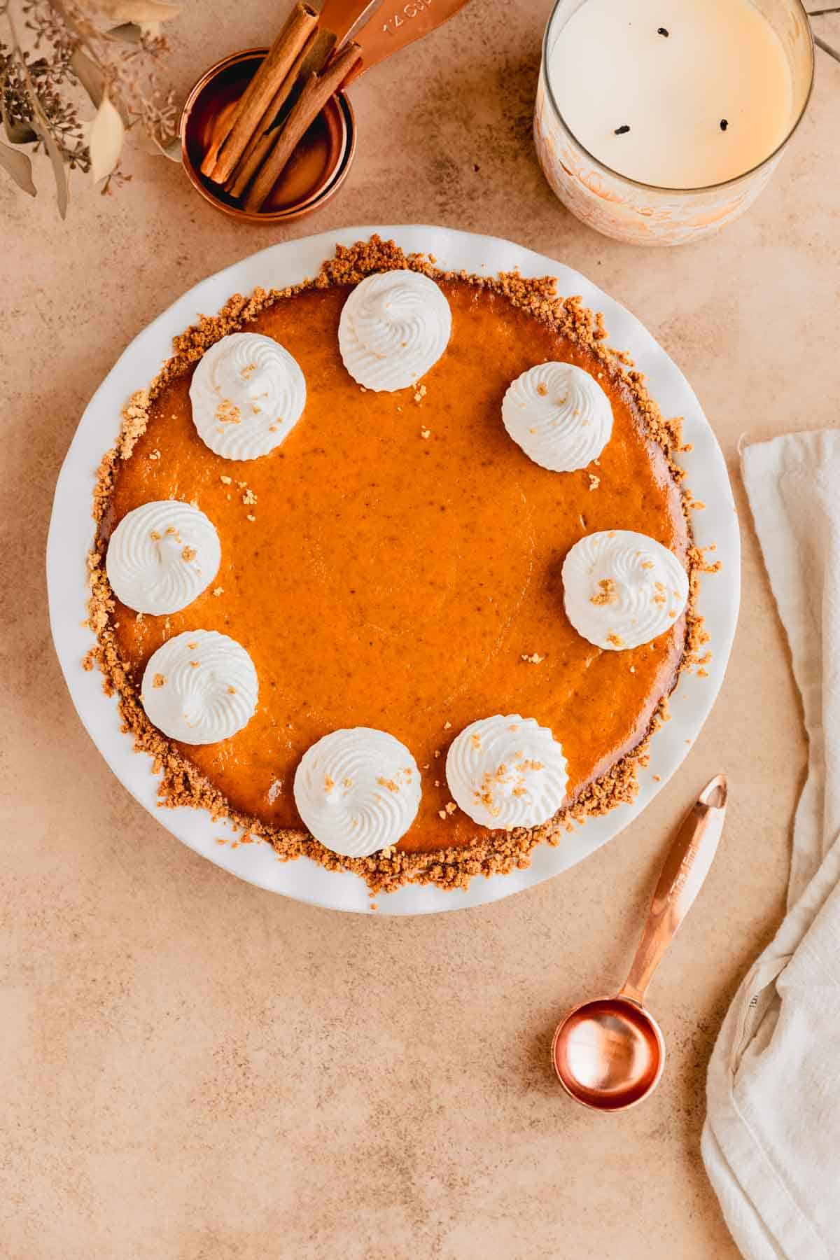 Pumpkin pie with graham cracker crust topped with maple whipped cream. 