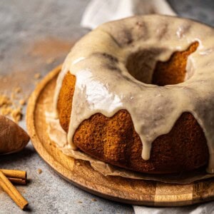 Sweet Potato Pound Cake topped with marshmallow glaze on a cake tray.