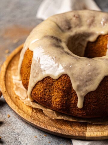 Sweet Potato Pound Cake topped with marshmallow glaze on a cake tray.