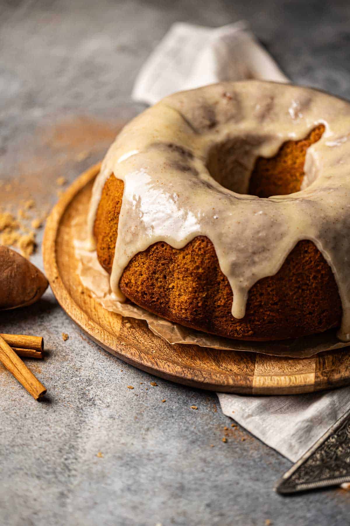 Sweet Potato Pound Cake with marshmallow glaze on a cake board.