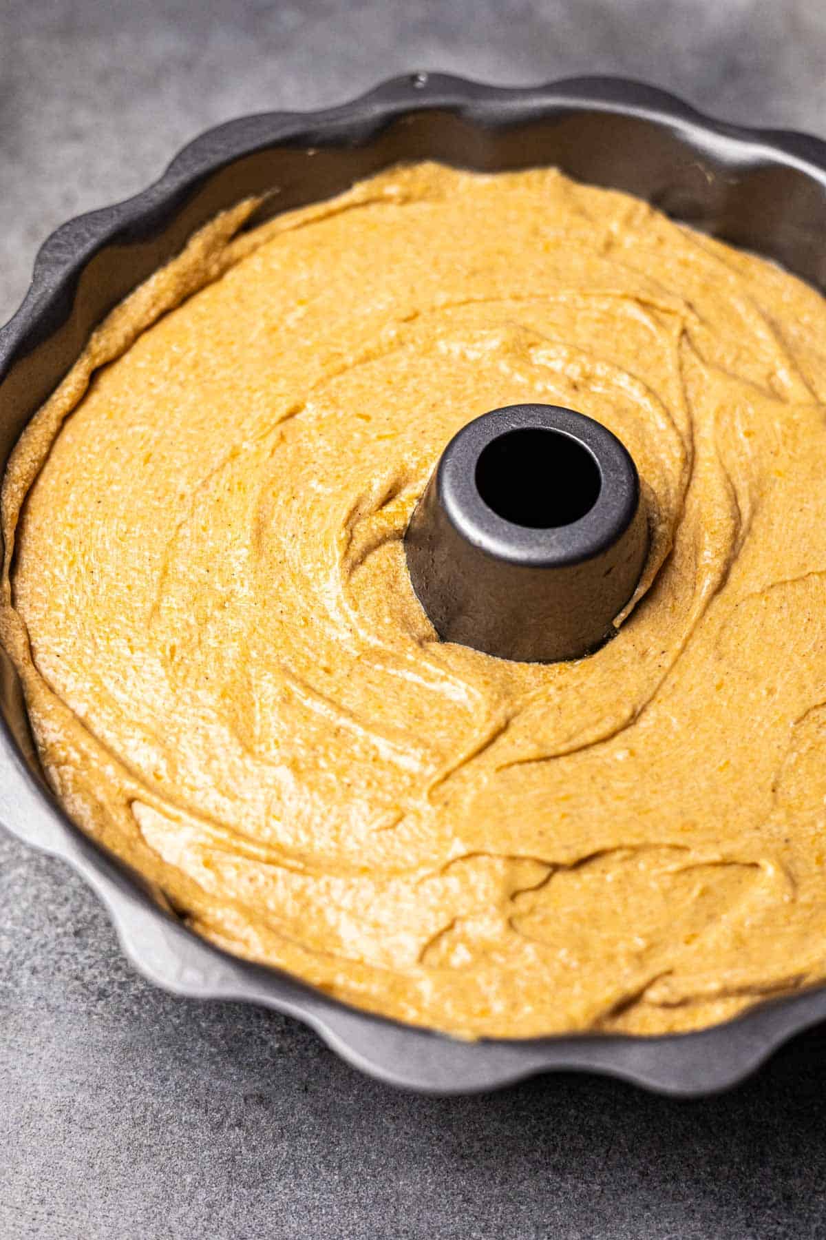 Sweet potato pound cake batter poured into the bundt cake pan. 