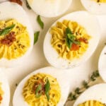 Deviled Eggs with Relish topped with bacon and green onions.