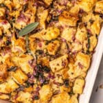Sourdough stuffing with herbs in a baking dish.