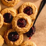 Peanut Butter Thumbprint Cookies with raspberry jelly in the center.