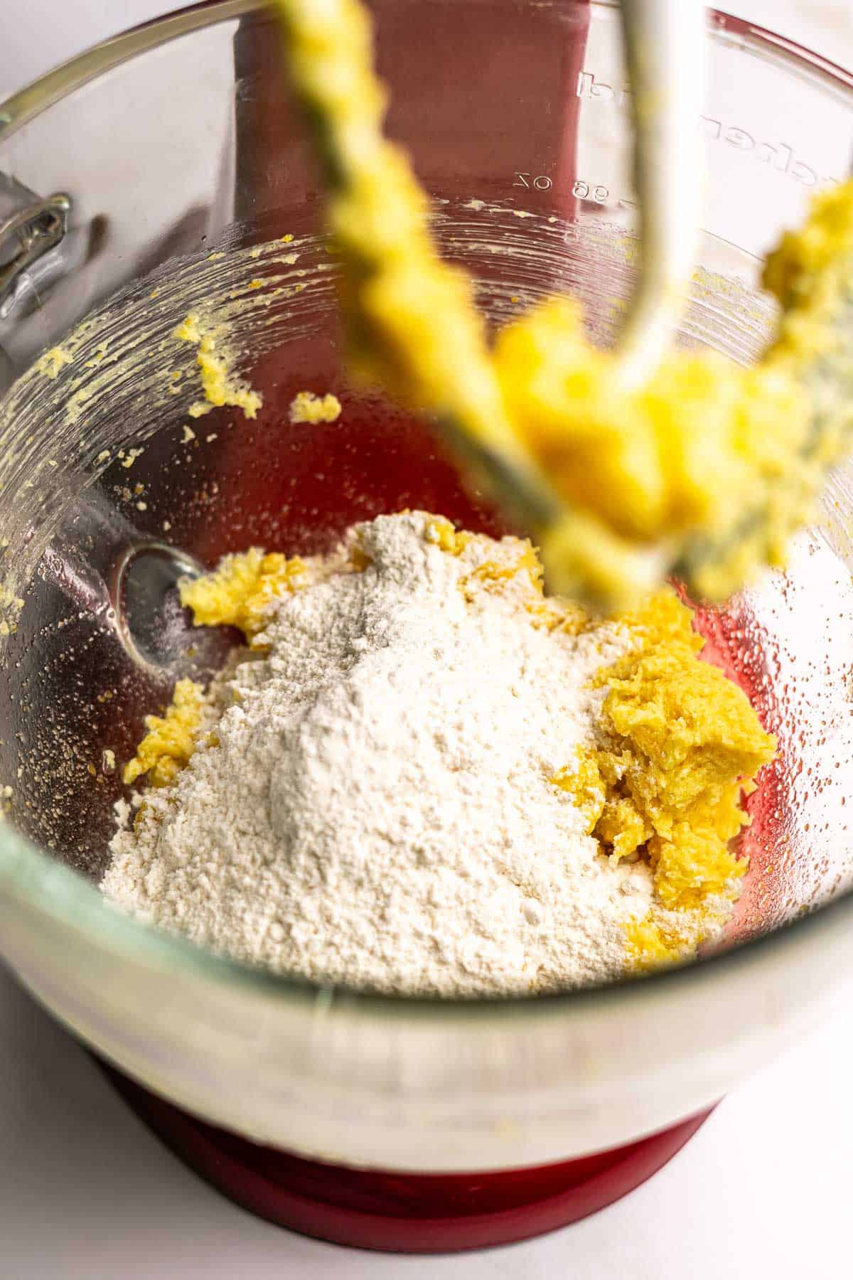 Dry ingredients mixed into the wet ingredients in the bowl of a stand mixer. 
