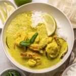 Thai Green Curry with shrimp, rice and eggplant in a bowl.