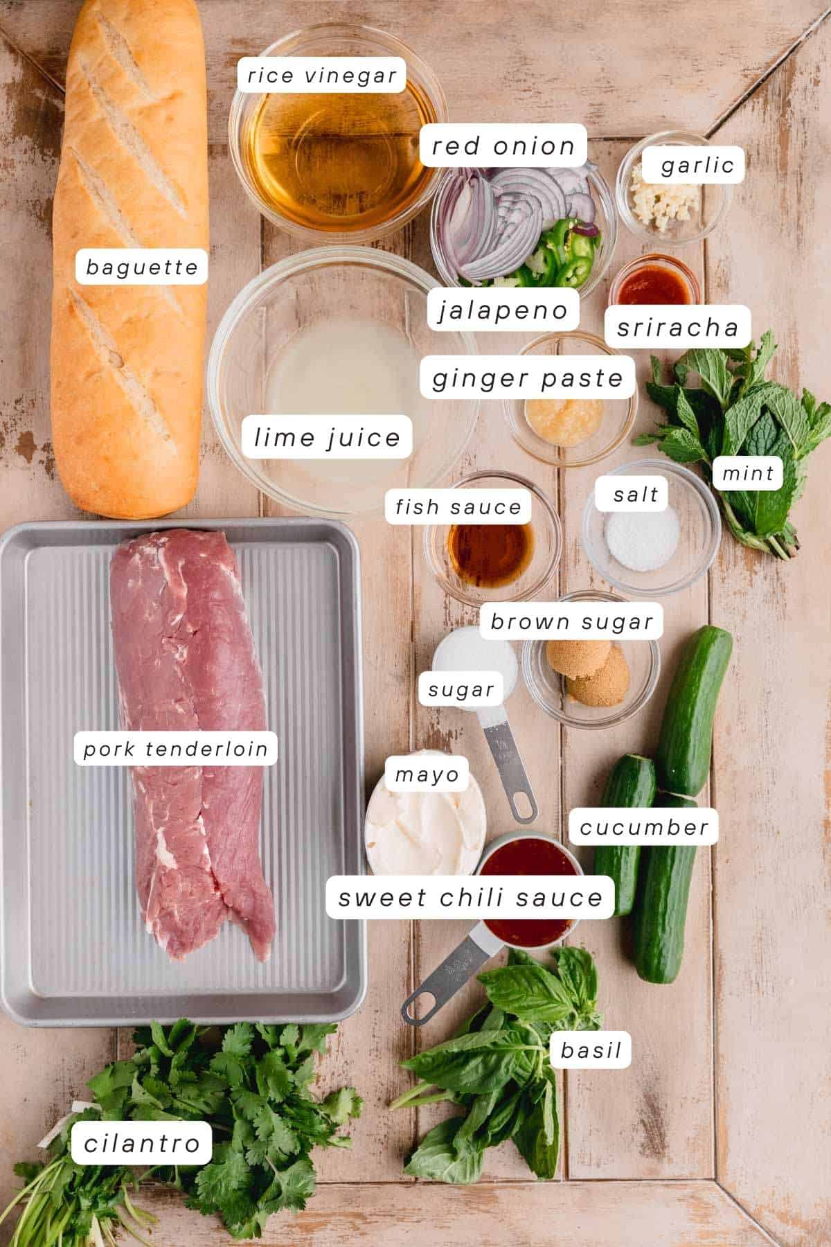Baguette, pork tenderloin, rice vinegar, lime juice, red onions, jalapenos, sriracha, mint, garlic, salt, fish sauce, sugar, brown sugar, ginger paste, cucumber, mint, cilantro, mayo and sweet chili sauce.