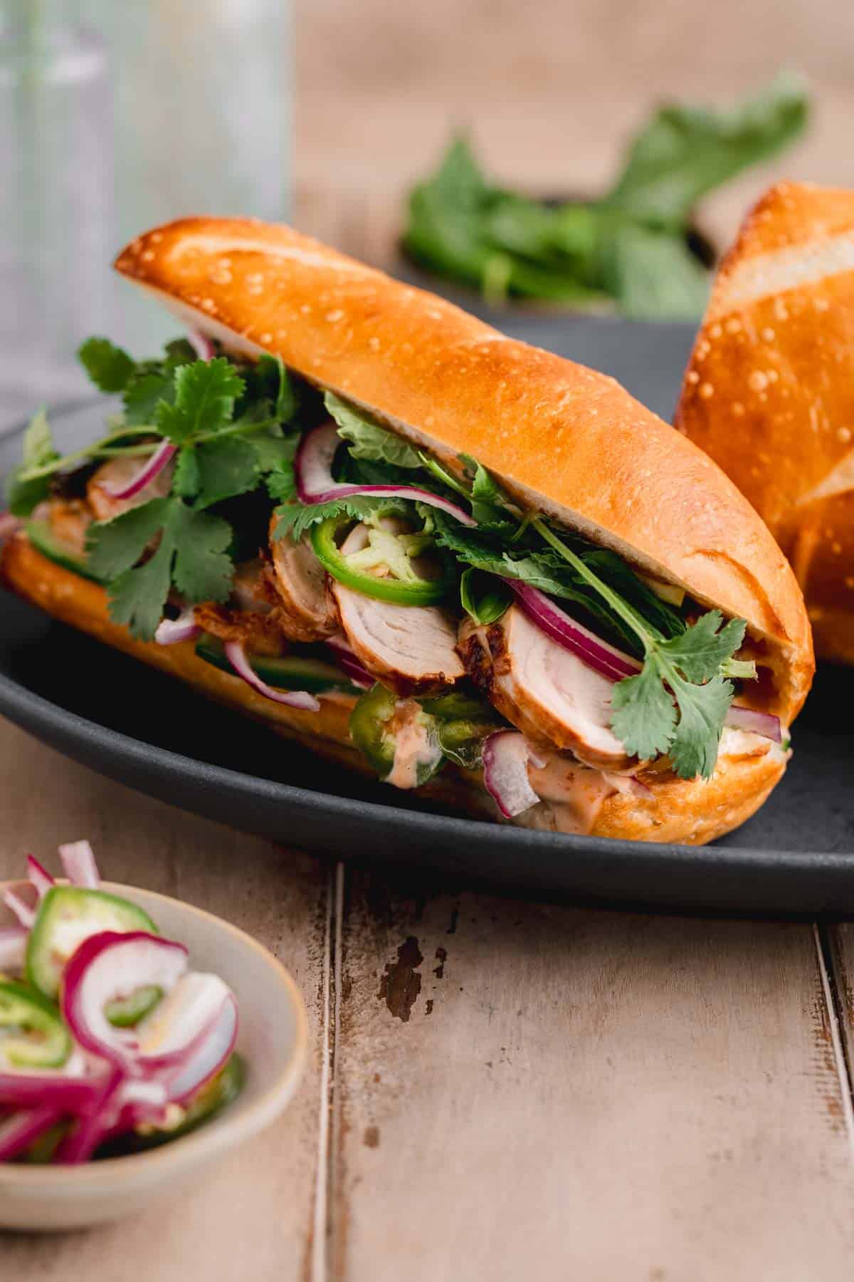 Pork tenderloin Banh Mi with onions, herbs and sweet chili mayo.