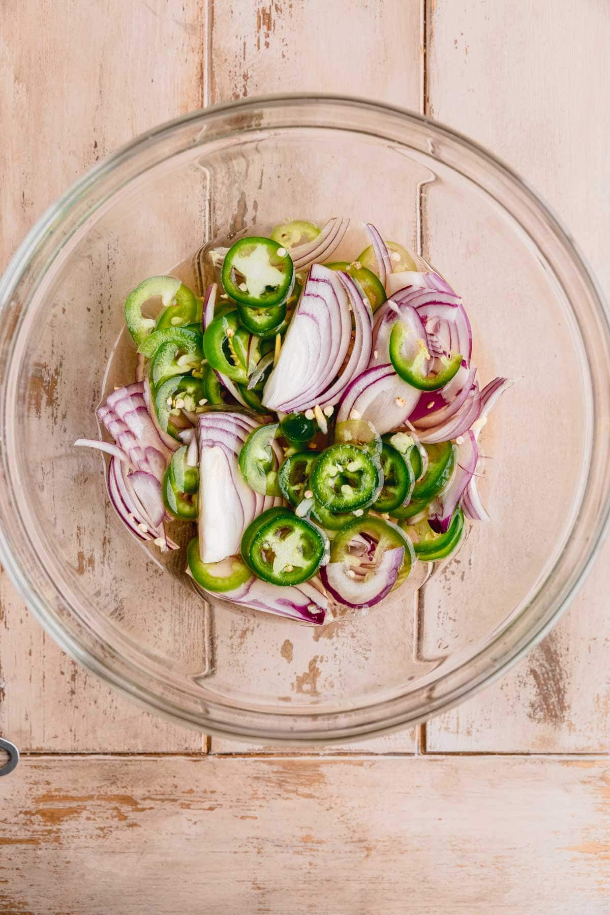 Pickled onions and jalapenos in a bowl.