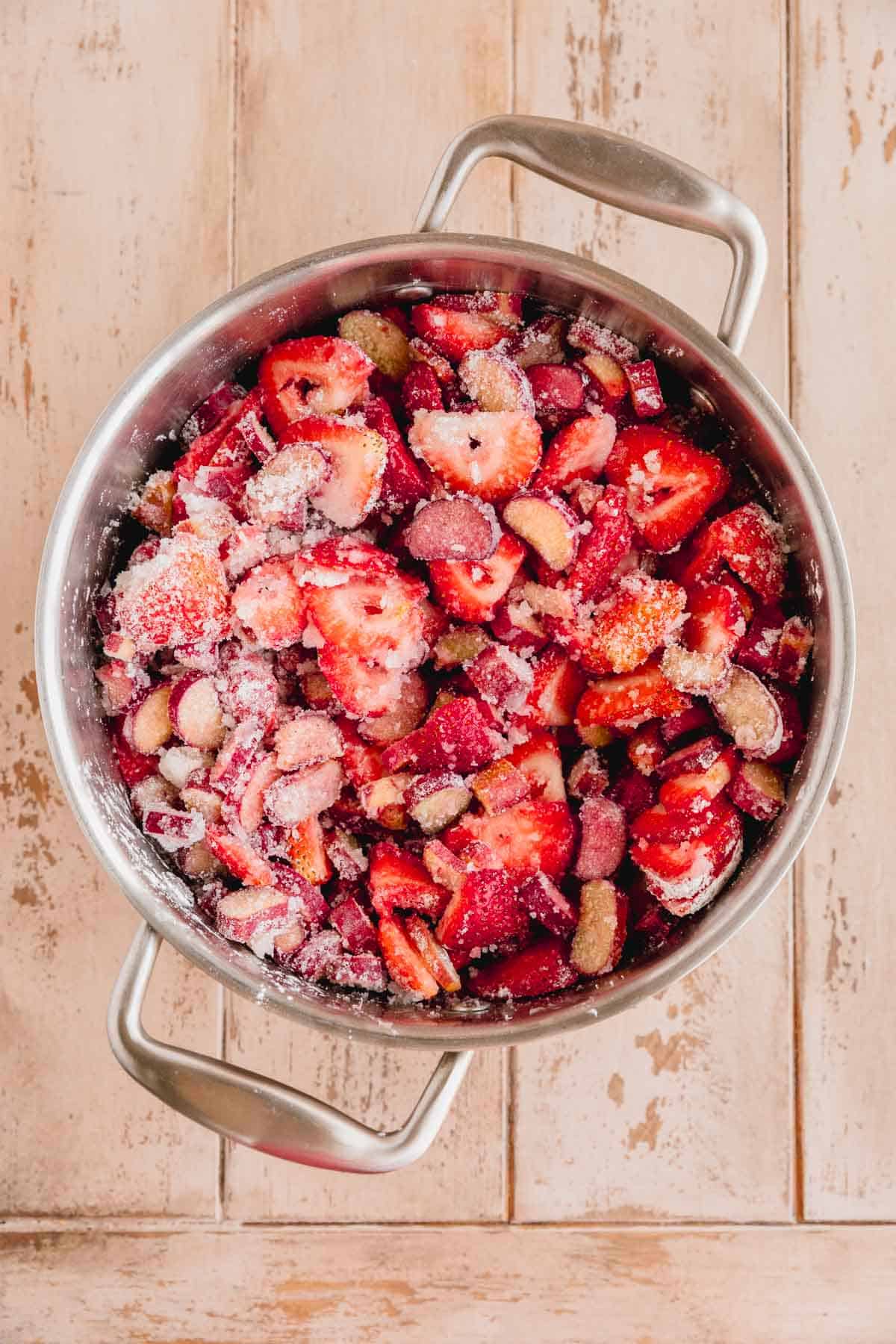 Strawberry and rhubarb in a pot with sugar, spices and cornstarch. 