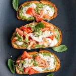 Walnut Pesto Bruschetta with Burrata on a serving dish.