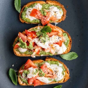 Walnut Pesto Bruschetta with Burrata on a serving dish.